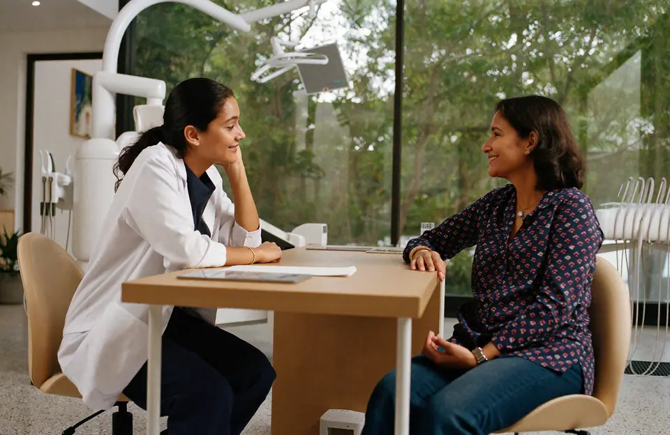 A dentist in conversation with a patient